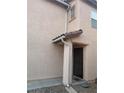 Front door with a screen and tile overhang on a tan stucco home at 11177 Deluna St, Las Vegas, NV 89141