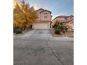 Two-story home with a two-car garage and a long driveway on a sunny day at 11177 Deluna St, Las Vegas, NV 89141