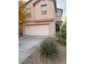 Two-story house with a two-car garage, complemented by desert landscaping at 11177 Deluna St, Las Vegas, NV 89141