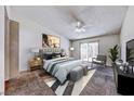 Cozy main bedroom showcasing a sliding door, ceiling fan, and neutral-toned decor at 5255 Dickens Dr # 0, Las Vegas, NV 89119