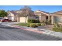 Single-Gathering home with desert landscaping, a two-car garage, and a red tiled roof at 7936 Pinnochio Ave, Las Vegas, NV 89131