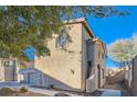 Tan two-story house with a landscaped yard and attached garage at 9790 Overlook Ridge Ave, Las Vegas, NV 89148