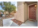 Dark brown front door with a decorative doormat at 9790 Overlook Ridge Ave, Las Vegas, NV 89148