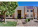 Well-maintained building exterior with desert landscaping, mature trees, and tile accents at 5301 River Glen Dr # 210, Las Vegas, NV 89103
