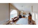 Spacious living room with vaulted ceilings, fireplace, and ample natural light at 3490 S Adobe Ct, Pahrump, NV 89048