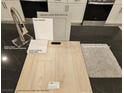 Sample board of kitchen finishes, including white cabinets and stainless steel appliances at 7116 Parkallen Ave, Las Vegas, NV 89113