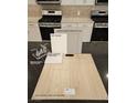 Sample board of kitchen finishes, with gray cabinets and stainless steel appliances at 7116 Parkallen Ave, Las Vegas, NV 89113