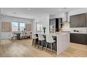 Open concept kitchen with an island, bar stool seating, and a dining area with bright natural light at 9002 Shifting Skye St, Las Vegas, NV 89166
