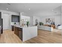 Spacious kitchen featuring a large island with stone countertops, stainless appliances, and an open-concept design at 9002 Shifting Skye St, Las Vegas, NV 89166