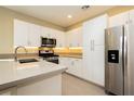 Modern kitchen with stainless steel appliances and white cabinetry at 11236 Rainbow Peak Ave # 210, Las Vegas, NV 89135