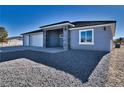 New single-story home with three-car garage and stone accents at 1761 Moose St, Pahrump, NV 89048