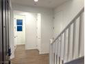 Bright entryway with wood-look tile floor and staircase at 5076 Dule Grove St, Las Vegas, NV 89130