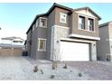 Two-story house with stone accents and a two-car garage at 5076 Dule Grove St, Las Vegas, NV 89130