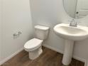 Small powder room with pedestal sink and tile floor at 5076 Dule Grove St, Las Vegas, NV 89130