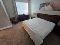 Spacious bedroom with large bed, dresser, and chair at 9050 W Tropicana Ave # 1135, Las Vegas, NV 89147