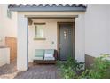 Inviting front porch features a cozy bench and a decorative front door, perfect for relaxing outdoors at 35 Flora Sagio Ave, Henderson, NV 89011