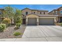 Two-story home features a three-car garage, desert landscaping, and a stucco exterior at 3605 Sapphire Sea Ct, North Las Vegas, NV 89031
