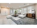 Bright, virtually staged living room featuring modern furniture and ample natural light at 3605 Sapphire Sea Ct, North Las Vegas, NV 89031