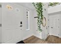 Light and airy entryway with white door, wood floors, and a charming plant at 2628 Starfish Ct, Las Vegas, NV 89128