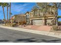 Two-story house with brick driveway and landscaping at 373 Via Sonador, Henderson, NV 89012