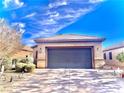 Exterior shot showing a well-kept home with desert landscaping and a spacious driveway at 4036 Shetland Pony St, Las Vegas, NV 89122