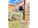 Exterior of home with desert landscaping, gravel, bushes, and patio area at 4036 Shetland Pony St, Las Vegas, NV 89122