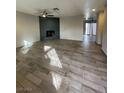 Spacious living room featuring a brick fireplace and wood-look tile floors at 2529 Rialto Rd, Las Vegas, NV 89108