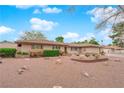 Single-story home exhibiting desert landscaping, lush green hedges, and a tidy front yard at 3690 S Rosecrest Cir, Las Vegas, NV 89121