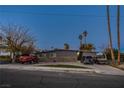 House exterior view with driveway, landscaping and two parked vehicles at 1625 Phillips Ave, Las Vegas, NV 89104