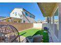 Landscaped backyard with patio furniture and artificial turf at 5029 Bloodhound St, Las Vegas, NV 89122