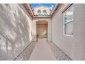 Inviting entryway with a walkway framed by decorative gravel leading to the front door at 952 Contadero Pl, Las Vegas, NV 89138