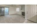 Living room with fireplace, sliding door to balcony and carpet flooring at 2725 S Nellis Blvd # 1096, Las Vegas, NV 89121