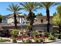 Scenic community entrance with lush landscaping, mature palm trees, and attractive signage at 716 Solitude Point Ave, Henderson, NV 89012