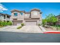 Inviting townhome exterior with attached two-car garage and spacious driveway at 716 Solitude Point Ave, Henderson, NV 89012