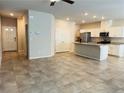 Spacious living room featuring tile flooring and an open floor plan that flows into the kitchen at 8279 Palladium St, Las Vegas, NV 89113