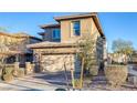 Two-story house with tan siding, a two-car garage, and landscaping at 356 Espressivo St, Henderson, NV 89011