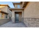 Front entrance with stone accents and a dark gray door at 356 Espressivo St, Henderson, NV 89011