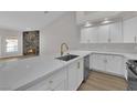 Modern kitchen with white cabinets, quartz countertops and gold faucet at 5404 Harmony Green Dr # 201, Las Vegas, NV 89149