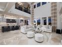 Open-concept living room boasts high ceilings and extends into a modern kitchen with seating at 2781 Josephine Dr, Henderson, NV 89044