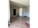 Open-concept living room with bright natural light, neutral paint, and tiled flooring provides a clean aesthetic at 1604 Luning Dr, Las Vegas, NV 89106