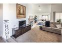 Spacious living room with fireplace, TV stand, and comfy seating at 2525 Kirkmichael Ln, Henderson, NV 89014