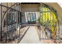 Ornate iron gate opens to a private front entry porch at 3544 Sandcliff Ln, Las Vegas, NV 89121