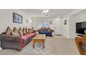 Cozy living room with brown sofa, coffee table, and flat-screen TV at 6058 Ambleshire Ave, Las Vegas, NV 89139