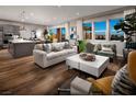 Open living area with hardwood floors and large windows at 10356 Aquila Crest Ave, Las Vegas, NV 89166
