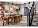 Dining area with wood table and chairs, hardwood floors, and stylish decor at 10363 Vista Argento Ave, Las Vegas, NV 89166