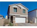 Two-story house with a white garage door and landscaping at 4132 Spring Storm Ave, North Las Vegas, NV 89081