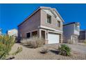 Two-story house with a white garage door and desert landscaping at 4132 Spring Storm Ave, North Las Vegas, NV 89081