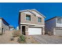 Two-story house with a white garage door and landscaping at 4132 Spring Storm Ave, North Las Vegas, NV 89081