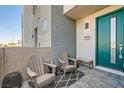 Inviting front patio with teal door and two armchairs at 4294 Eagle Summit Ave # 0, Las Vegas, NV 89141