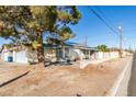 Single-story home with a front yard and attached garage at 4690 E Utah Ave, Las Vegas, NV 89104